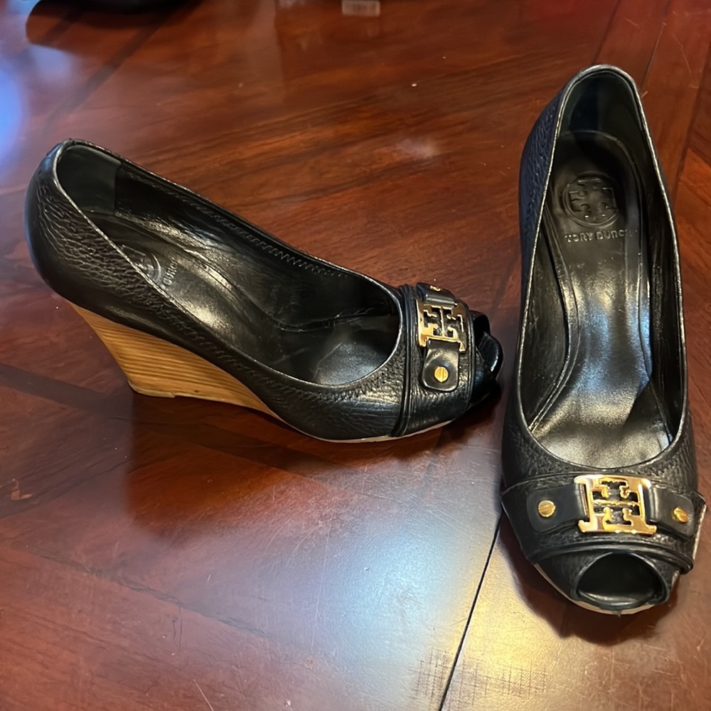 Tory Burch 7 1/2 peep toe wedge. Black leather. Gold embellishment.